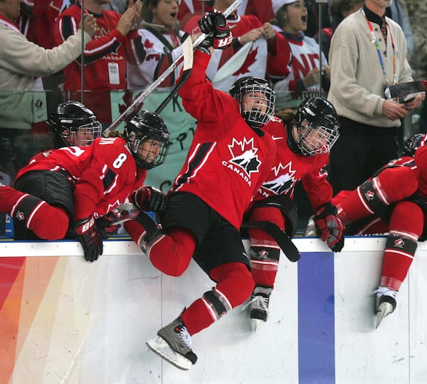 FILE - Team Canada's Jennifer Botterill, center, and other team members leap from the bench to celebrate defeating Sweden 4-1 in the women's ice hockey gold medal match at the 2006 Turin Winter Olympic Games in Turin, Italy on Feb. 20, 2006. (AP Photo/Julie Jacobson, File)