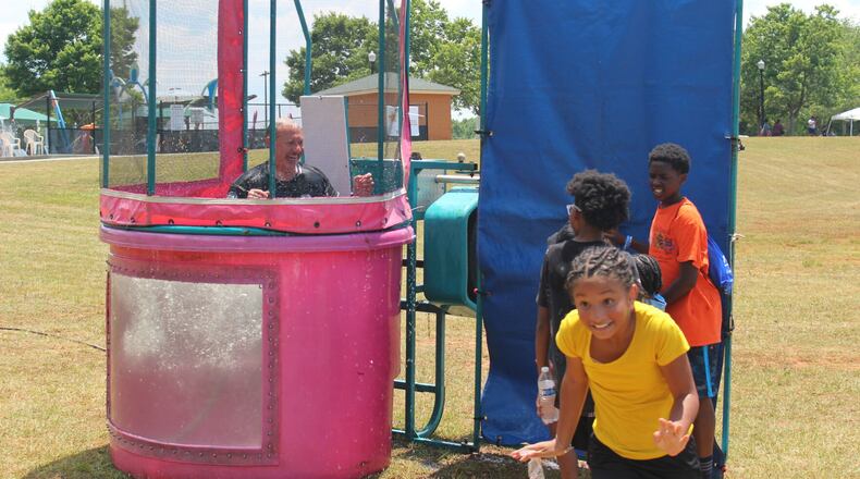 Kennesaw Police Chief Bill Westenberger smiles after being dunked in water by a group of children at the fourth annual “Unity in the Community: A Juneteenth Celebration of Unity” event on Saturday at Swift-Cantrell Park in Kennesaw.