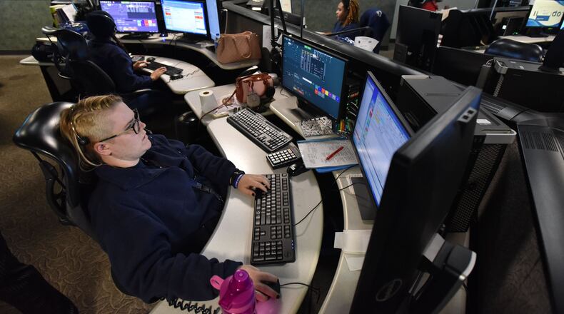 DeKalb County dispatchers assist callers at the 911 emergency center in Tucker on Friday. HYOSUB SHIN / HSHIN@AJC.COM