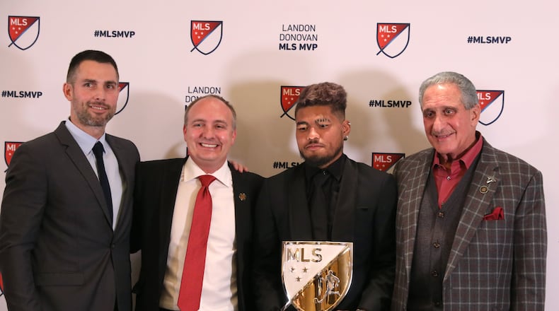 Atlanta United forward Josef Martinez, center, poses with Carlos Bocanegra, Atlanta United VP and Technical Director, Darren Eales, Atlanta United President, and Arthur Blank, Atlanta United Owner, after Martinez was awarded the MLS MVP at the Arthur M. Blank Family Office Wednesday, December 5, 2018, in Atlanta. (JASON GETZ/SPECIAL TO THE AJC)
