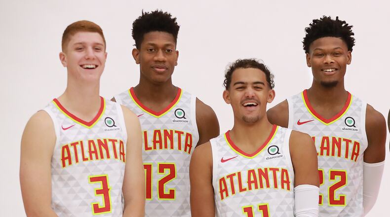 Hawks players (from left) Kevin Huerter, DeAndre Hunter, Trae Young and Cam Reddish.
