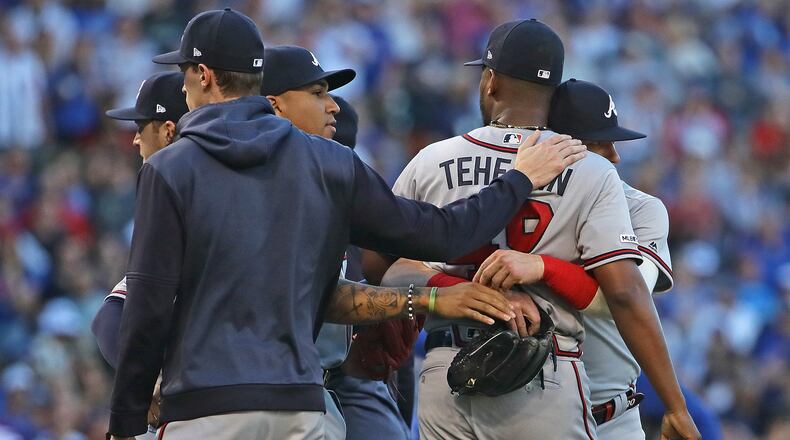 Players hold Julio Teheran during a brief altercation in the second inning of Monday's Braves-Cubs game at Wrigley Field. (Photo by Jonathan Daniel/Getty Images)