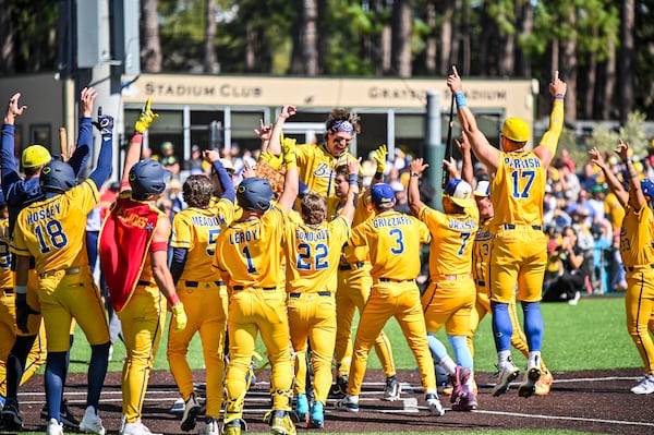 Savannah Bananas players celebrate a home run during the Savannah Bananas and Texas Tailgaters preseason game on Feb. 22, 2026, at Grayson Stadium in Savannah, Ga. (Sarah Peacock for the AJC)