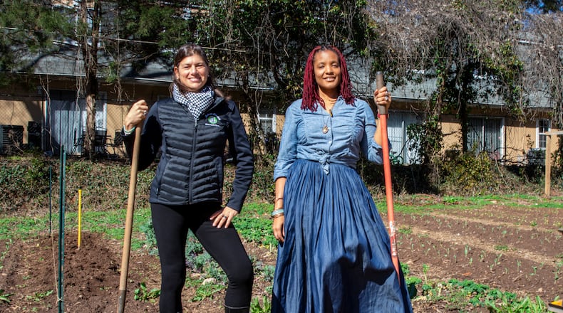 Leslie Zinn (left), CEO of Arden's Garden, and Yennenga Adanya, founder of Oyun Botanical Gardens, partnered to keep the urban farm located in East Point from being purchased and redeveloped. (Courtesy of Arden's Garden)