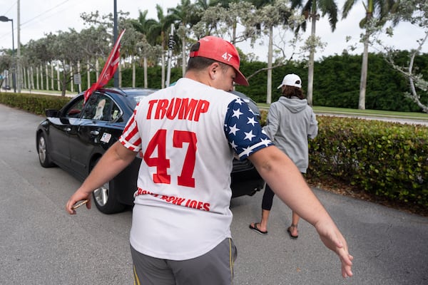 Jared Petry, a supporter of President Donald Trump, wears a number 47 Trump shirt as he joins other Trump supporters outside the Trump International Golf Club, Saturday, March 29, 2025, in West Palm Beach, Fla. (AP Photo/Manuel Balce Ceneta)