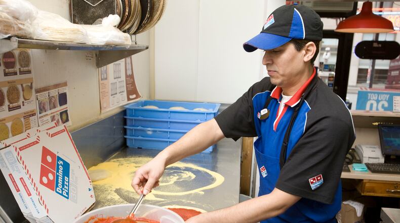 A pizza being made at Domino's. Photo Credit: Domino's Pizza