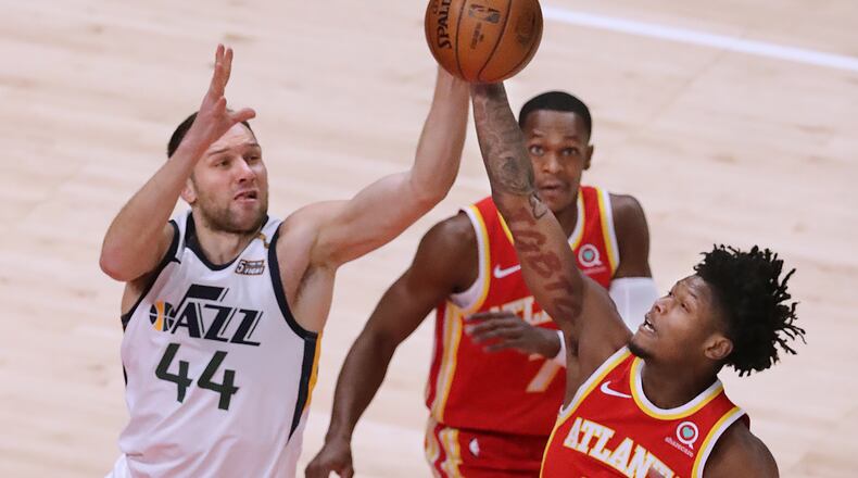 020421 Atlanta: Atlanta Hawks guard Cam Reddish battles Utah Jazz forward Bojan Bogdanovic for a loose ball in an NBA basketball game on Thursday, Feb 4, 2021, in Atlanta.      Curtis Compton / Curtis.Compton@ajc.com”