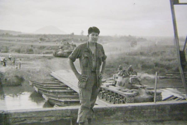 This photo provided by George Bennett shows Bennett during his service in Vietnam from 1966 to 1967, guarding a foot bridge over the Sairon River near the Dau Tieng base. (George Bennett via AP)