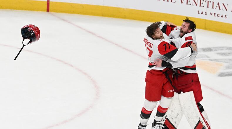 Carolina Hurricanes left wing Mark Jankowski (77) and goaltender Brandon Bussi (32) celebrate after a win over the Vegas Golden Knights in Game 6 of the NHL hockey Stanley Cup Final series, Sunday, June 14, 2026, in Las Vegas. (AP Photo/Candice Ward)