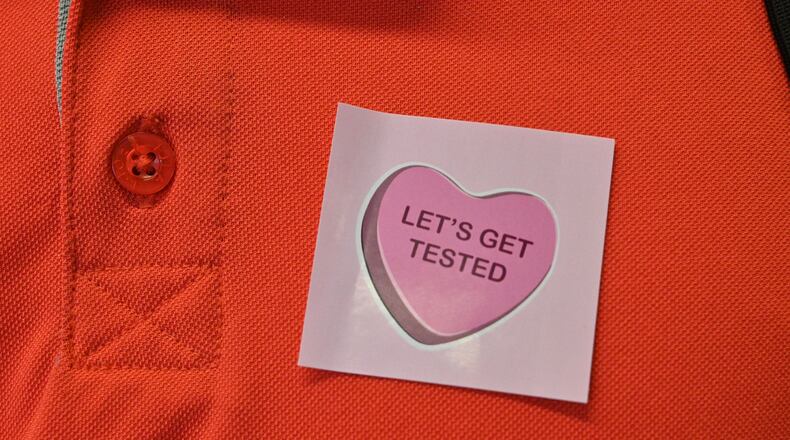 January 4, 2022 Atlanta - Georgia Tech employee Donald Smith gets a sticker after he submitted his saliva sample for PCR COVID-19 test at Georgia Tech’s Economic Development Building on Tuesday, January 4, 2022. (Hyosub Shin / Hyosub.Shin@ajc.com)