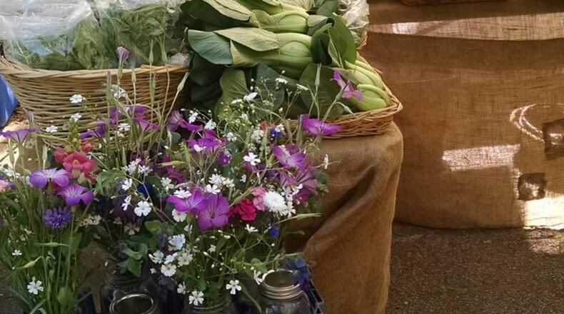 An urban farm can supply everything from organic vegetables to bouquets of flowers. Freewheel Farm grows crops on three city lots and brings their produce to the Grant Park Farmers Market, less than a mile from two of the three farm properties. / Photo credit: Freewheel Farm