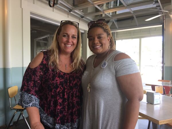 (l-r) Tamara Stevens and Essence Johnson during a lunchtime strategizing session last week. Stevens, a Roswell mother of three who posts amusing instructional videos of herself canvassing potential 6th District special election voters on Facebook, and Johnson, an East Cobb mother of a 4-year-old who's now thinking of running for office herself, were meeting to figure out ways to coordinate some of their activism efforts. Photo by Jill Vejnoska/jvejnoska@ajc.com