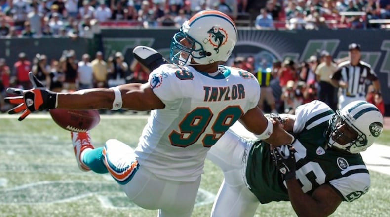 New York Jets Erik Coleman, right, breaks up a pass intended for Miami Dolphins defensive end Jason Taylor during second-quarter NFL football Sunday, Sept. 23, 2007, at Giants Stadium in East Rutherford, N.J. Coleman was penalized for pass interference. (AP Photo/Bill Kostroun)
