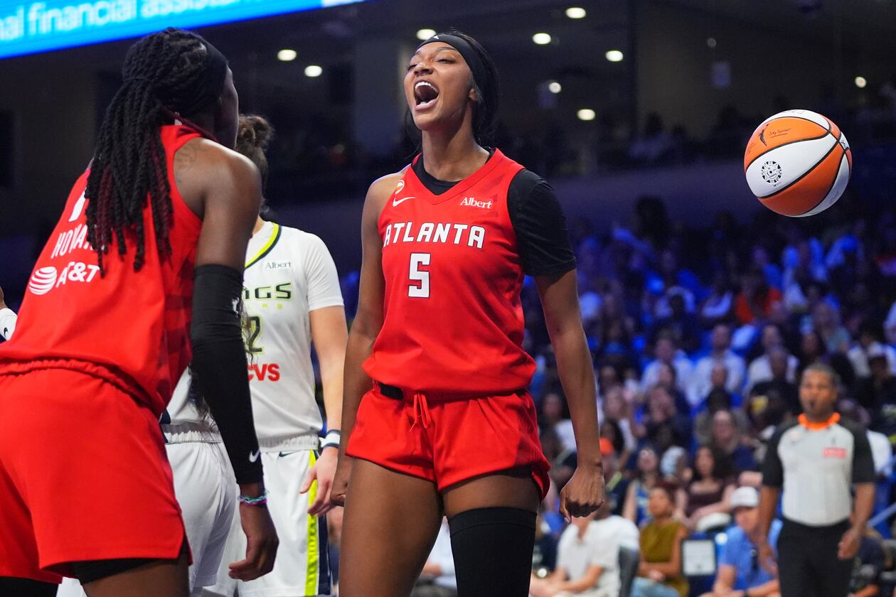 Atlanta Dream forward Angel Reese (5) reacts to scoring with teammate Rhyne Howard (10) during the second half of a WNBA basketball game against the Dallas Wings in Arlington, Texas, Wednesday, July 29, 2026. (LM Otero/AP)