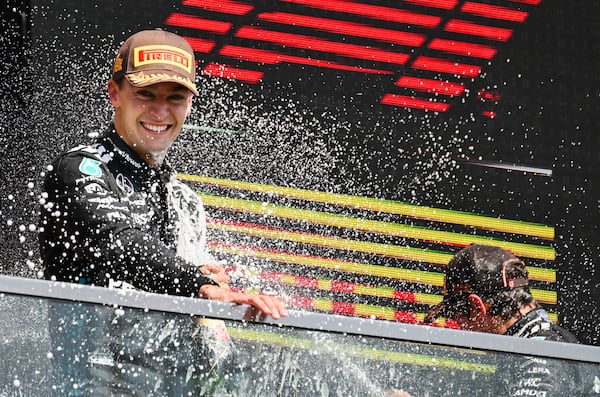 Mercedes driver George Russell, left, of the United Kingdom, left, is sprayed by teammate Kimi Antonelli, right, of Italy, after winning the F1 Canadian Grand Prix auto race in Montreal, Sunday, June 15, 2025. (Graham Hughes/The Canadian Press via AP)