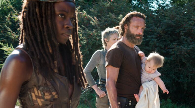 Michonne, Carol and Rick (with Judith) check out their new surroundings in Alexandria. CREDIT: AMC