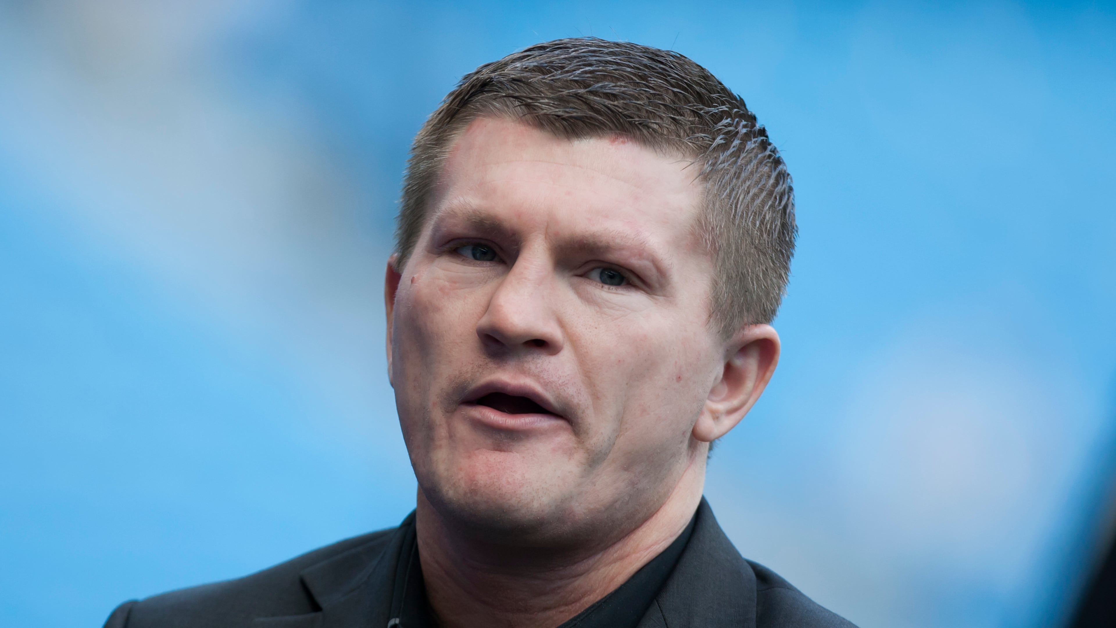 FILE - Boxer Ricky Hatton stands by the pitch before Manchester City's English Premier League soccer match against Manchester United at the Etihad Stadium, Manchester, England, Sunday Sept. 22, 2013. (AP Photo/Jon Super, File)