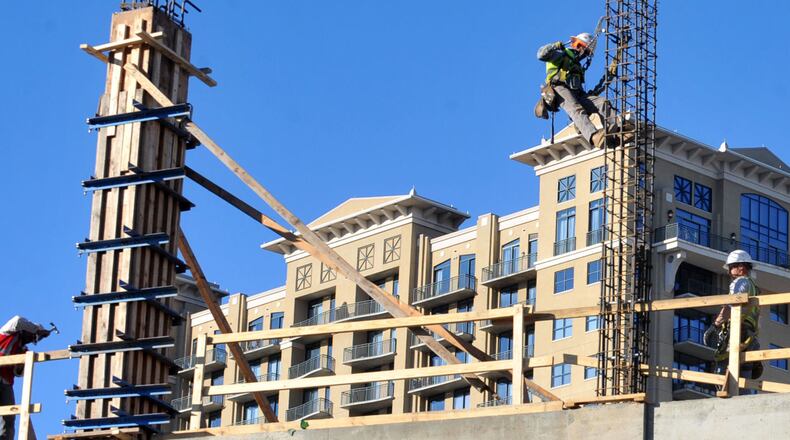 Cranes rise above work construction work on the Streets of Buckhead development at Pharr Road and Peachtree Road.