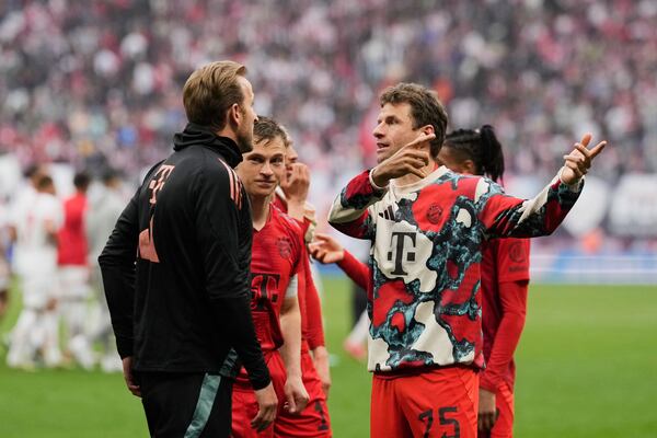 Bayern's Thomas Mueller speaks with teammate Harry Kane, left, on the pitch at the end of the German Bundesliga soccer match between RB Leipzig and FC Bayern Munich at the Red Bull Arena in Leipzig, Germany, Saturday, May 3, 2025. (AP Photo/Matthias Schrader)