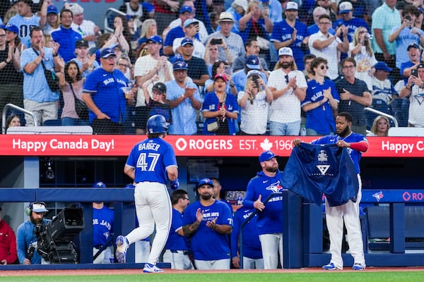Toronto Blue Jays' Addison Barger (47) celebrates after his solo home run with Vladimir Guerrero Jr., front right, during fifth-inning baseball game action against the New York Yankees in Toronto, Thursday, July 3, 2025. (Thomas Skrlj/The Canadian Press via AP)