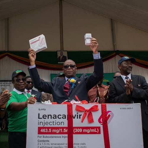 FILE - Zimbabwe's Minister of Health and Child Care Douglas Mombeshora holds up containers of lenacapavir, a new HIV prevention drug, during its launch in Harare, Zimbabwe, Thursday, Feb. 19, 2026. (AP Photo/Aaron Ufumeli, File)