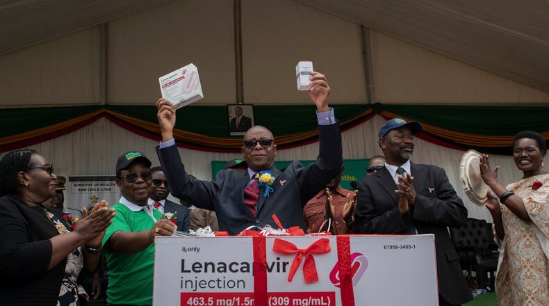 FILE - Zimbabwe's Minister of Health and Child Care Douglas Mombeshora holds up containers of lenacapavir, a new HIV prevention drug, during its launch in Harare, Zimbabwe, Thursday, Feb. 19, 2026. (AP Photo/Aaron Ufumeli, File)