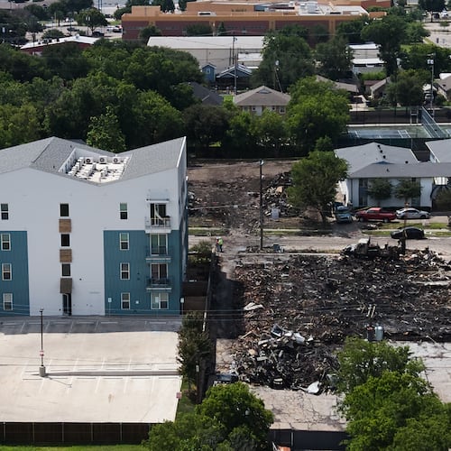 Damage is visible following an apartment complex fire, Friday, May 29, 2026, in Dallas. (AP Photo/Julio Cortez)