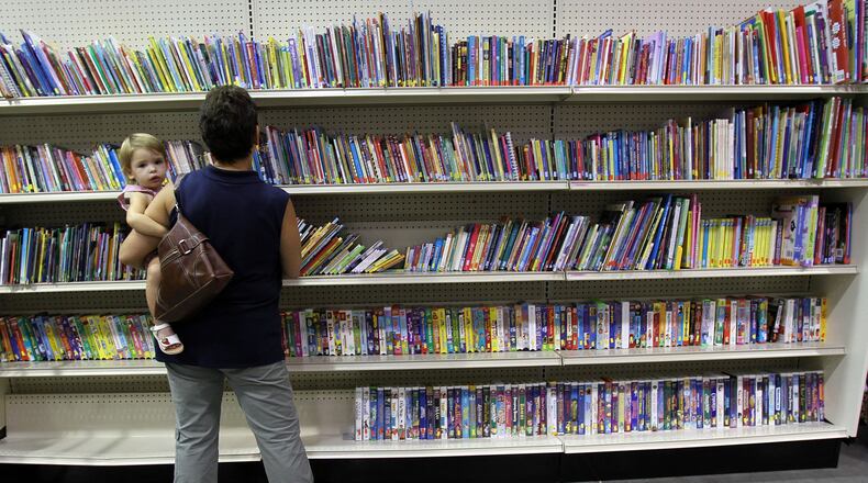 Perusing books at the Dunwoody Goodwill. AJC FILE