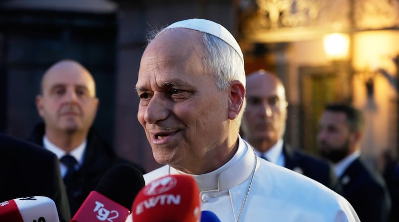 Pope Leo XIV talks to journalists as he leaves his residence in Castel Gandolfo, on the outskirts of Rome, to return to the Vatican, Tuesday, May 5, 2026. (AP Photo/Gregorio Borgia)