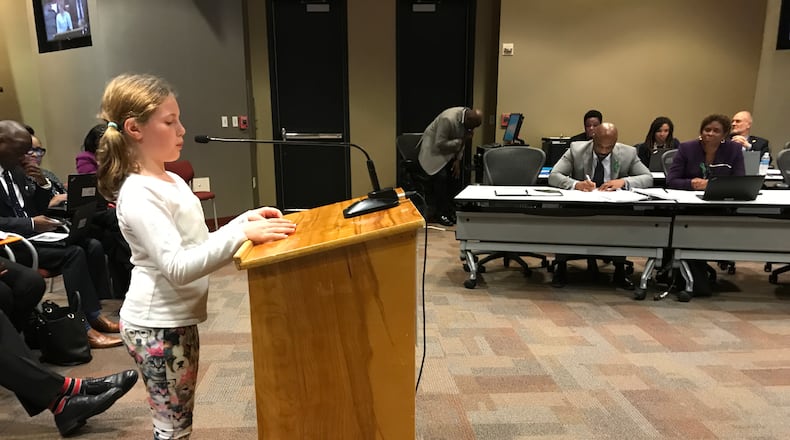 Falyn Handley, 10, a fifth grader at Springdale Park Elementary School, wears dog-print leggings while she addresses the Atlanta Board of Education on Monday to ask for an update to the district's student dress code policy. She collected more than 1,000 signatures on an online petition.