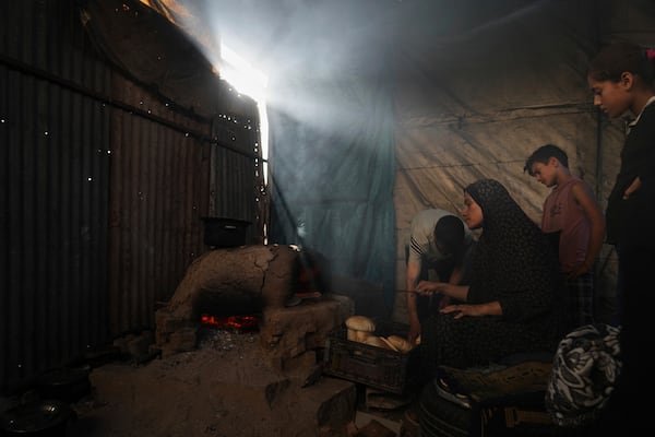 Displaced Palestinians bake bread in a school now serving as a shelter in Deir al-Balah, Gaza Strip Sunday, July 6, 2025. (AP Photo/Abdel Kareem Hana)