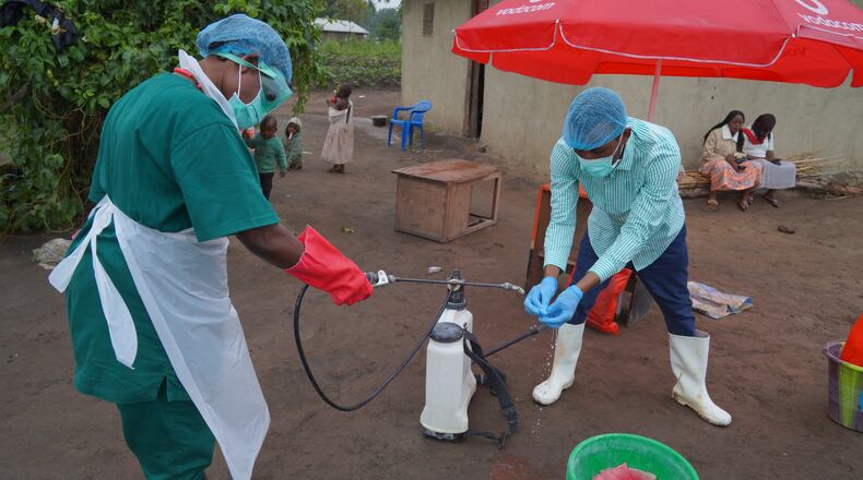 Wiza Bondele, Right, a health worker on the prevention and control team, seen at work in Ituri province, eastern Congo, Wednesday, Aug 5, 2026. (AP Photo/Dieudonne Dirole)