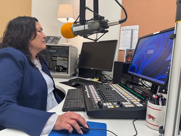 Jaclyn Sallee, president and chief operating for Koahnic Broadcast Corp.,starts a computer July 10, 2025, at the Anchorage, Alaska, studios of KBNA, the flagship station for National Native News. (AP Photo/Mark Thiessen)