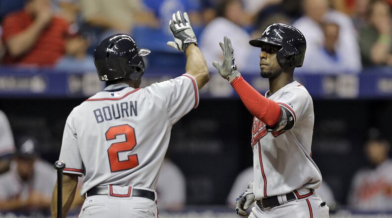 The Braves’ Pedro Ciriaco high-fives on-deck batter Michael Bourn after hitting a home run off Rays pitcher Jake Odorizzi during the fifth inning Wednesday, Aug. 12, 2015, in St. Petersburg, Fla. (AP Photo/Chris O’Meara)