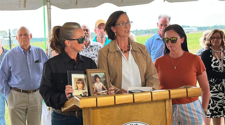 Lynn Cobb, center, speaks about her younger sister Cynthia Driggers while Driggers' niece Tanya Clement holds up photos of Cynthia Driggers after her killer, James Ernest Hitchcock, was executed on Thursday, April 30, 2026, in Starke, Fla. (AP Photo/Jeffrey Collins)