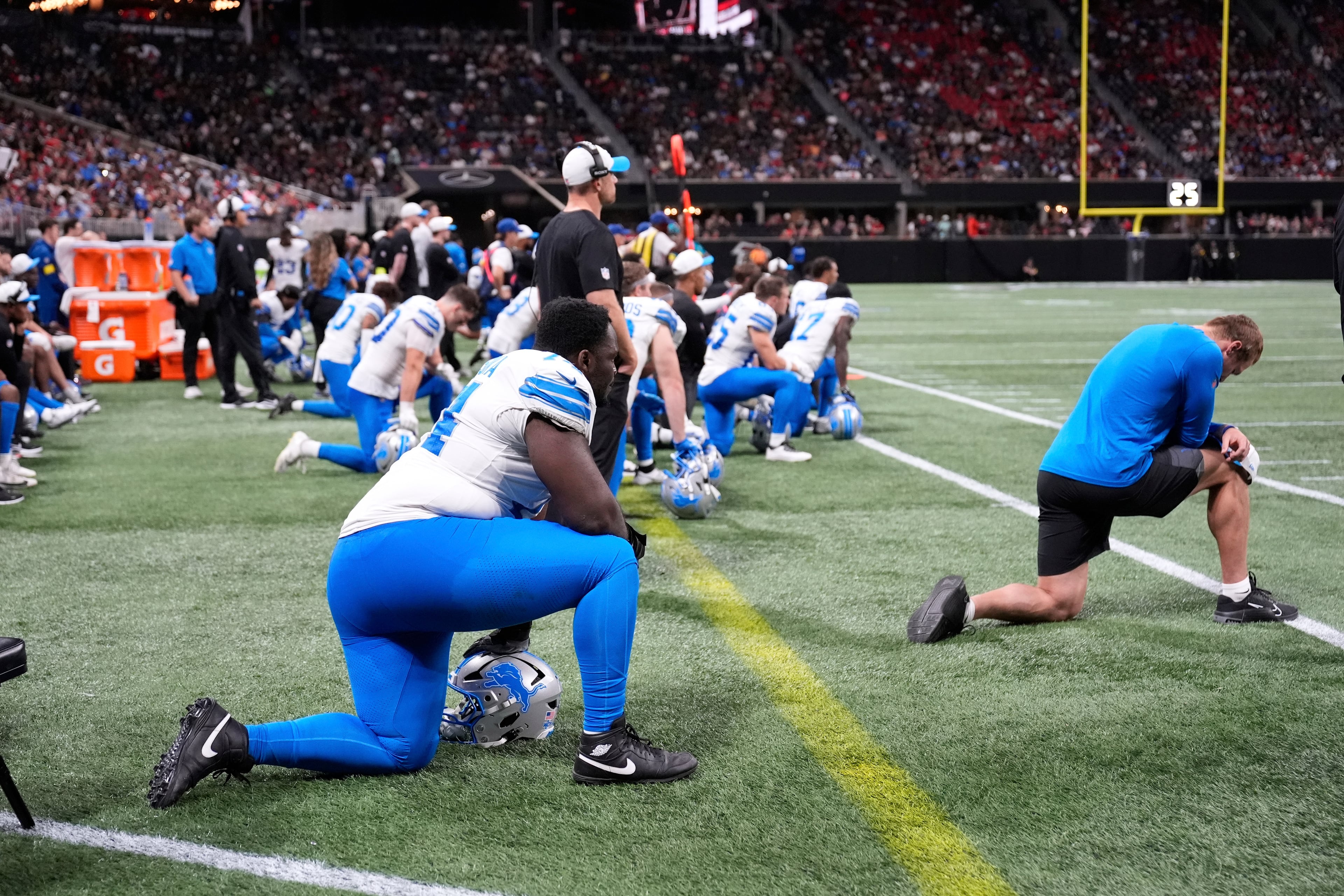 Detroit Lions players take a knee after safety Morice Norris was injured on Friday, Aug. 8, 2025, in Atlanta. (Brynn Anderson/AP)