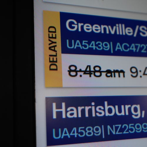 An information sign displays a delayed flight at O'Hare International Airport in Chicago, Friday, Nov. 7, 2025. (AP Photo/Nam Y. Huh)
