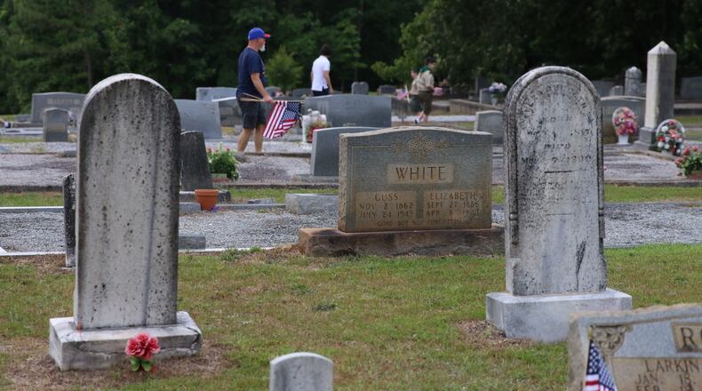 Volunteers shown here decorating the Sugar Hill Historic Cemetery. The city recently approved an increase from $500 to $1,000 for individual cemetery spaces with the buyer assuming any deed recording fees. (Courtesy City of Sugar Hill)