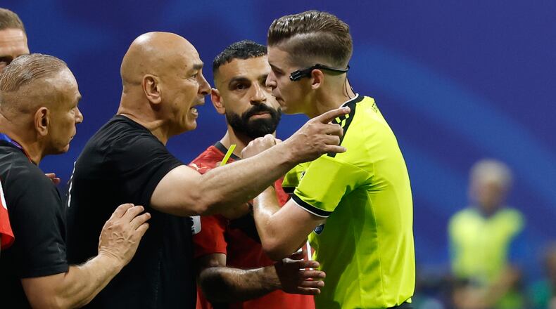 Egypt head coach Hossam Hassan argues with referee Francois Letexier, of France, during the World Cup round of 16 soccer match between Argentina and Egypt in Atlanta, Tuesday, July 7, 2026. (AP Photo/Erik S. Lesser)