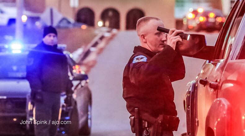 Officers are stopping vehicles coming out of an area subdivision to make sure the two men are not hiding inside them.