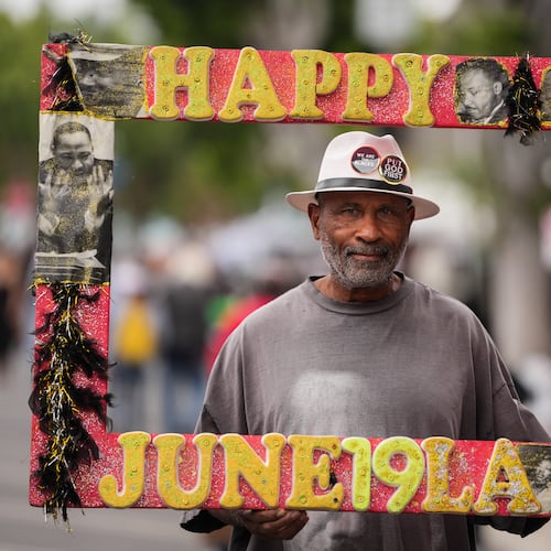 A person, who declined to give his name, stands for a photo during a Juneteenth celebration in the Leimert Park neighborhood of Los Angeles, Friday, June 19, 2026. (AP Photo/Jae C. Hong)