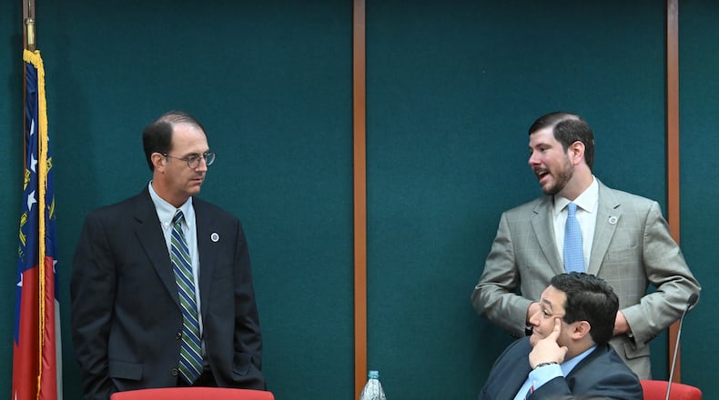 Georgia Ethics Commission members (clockwise from left) James Kreyenbuhl, then-commission vice chair, Robert Watts, and David Emadi, executive secretary, talk during a recess at an ethics commission meeting in 2020. (Hyosub Shin / Hyosub.Shin@ajc.com)