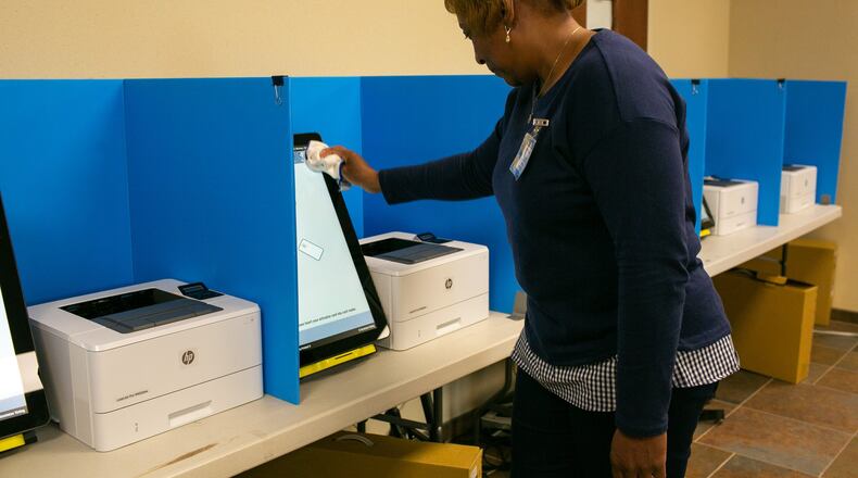 Carla, a polling assistant, cleans a polling machine at the Paulding County Municipal Building on Monday, Oct. 14, 2019, in Dallas, Georgia. Paulding County tested Georgia’s new voting machines on Monday during their municipal election. Paulding, along with six other counties, were the first to test the new machines that will be in all polling stations in the state for the first presidential primary election. (Photo/Rebecca Wright for the Atlanta Journal-Constitution)
