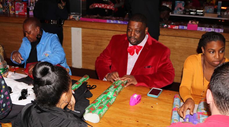 The gift wrapping event from the annual “Dads, Daughters, and Dolls” drive in December 2016.