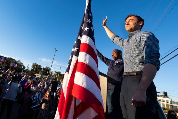 Democratic candidates for U.S. Senate Jon Ossoff (right)  and Raphael Warnock acknowledge a crowd of supporters during a meet and greet at the Cobb Civic Center on Nov. 15, 2020, in Marietta, Ga. (John Amis for the AJC)