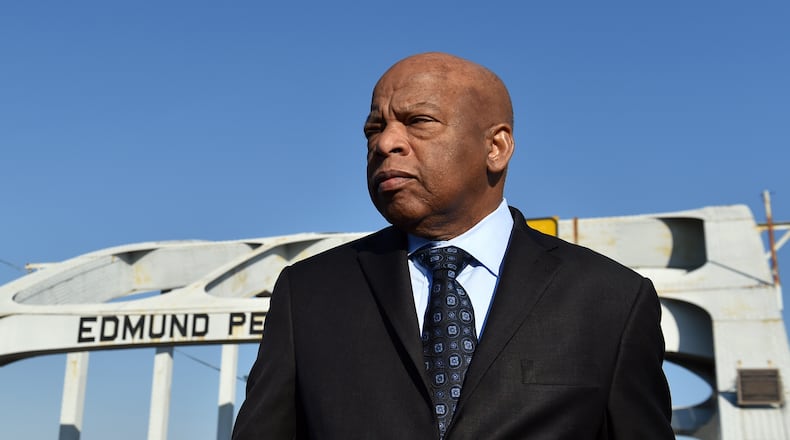 Congressman John Lewis on the Edmund Pettus Bridge February 14, 2015. On March 7, 1965  Hosea Williams and John Lewis  led 600 civil rights activists across the Edmund Pettus Bridge in a march for voting rights.  Lewis had no idea  the level of violence that awaited the group on the other side of the bridge. In what would become known around the country as as Bloody Sunday, state troopers and sheriff deputies used tear gas and clubs to break up the march.  Leaving Lewis with a skull fracture and sending more than 50 others to the local hospital for treatment.   BRANT SANDERLIN / BSANDERLIN@AJC.COM