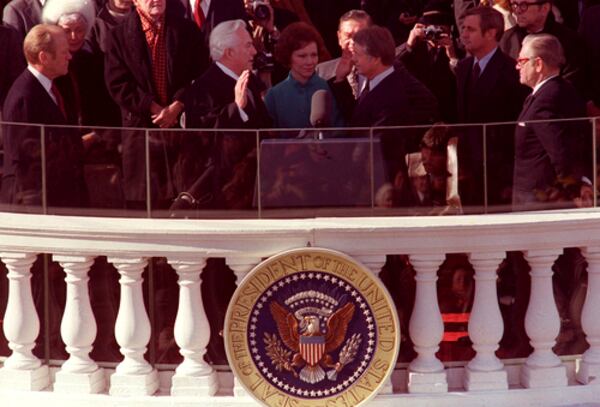 Jimmy Carter takes the oath of office, as his wife, Rosalynn, holds the family Bible during his inauguration ceremony in January 1977. (AP FILE)