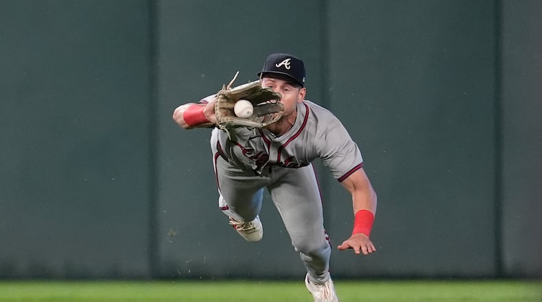 Atlanta Braves center fielder Jarred Kelenic catches a flyout hit by Minnesota Twins' Kyle Farmer during the second inning of a baseball game Monday, Aug. 26, 2024, in Minneapolis. (AP Photo/Abbie Parr)