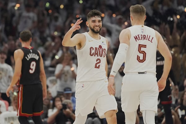 Cleveland Cavaliers guard Ty Jerome (2) congratulates teammate Sam Merrill (5) after Merrill hit a three point basket in the first half in Game 2 of an NBA first-round playoff series, Wednesday, April 23, 2025, in Cleveland. (AP Photo/Sue Ogrocki)