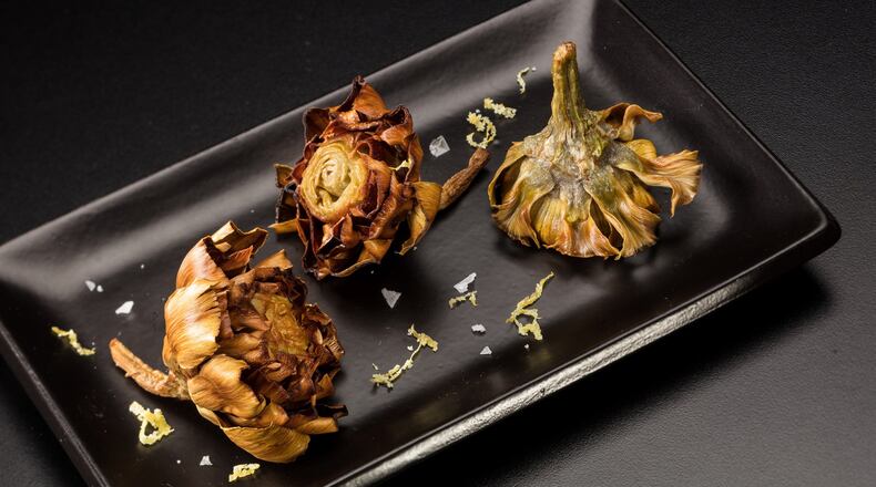 Baby artichokes are poached in oil, then crisped up in oil again before serving, sprinkled with a lemon zest and salt seasoning. (Food styling by Joan Moravek.) (Zbigniew Bzdak/Chicago Tribune/TNS)